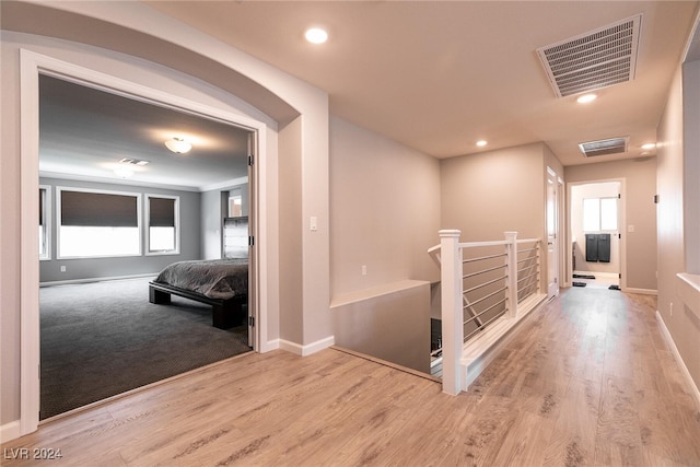 hall featuring plenty of natural light and light hardwood / wood-style floors