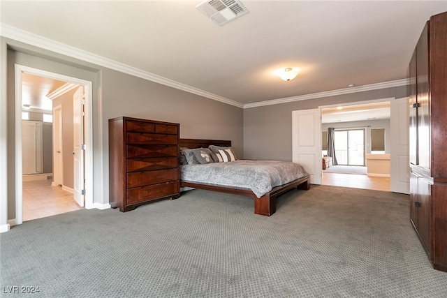 carpeted bedroom featuring crown molding and connected bathroom