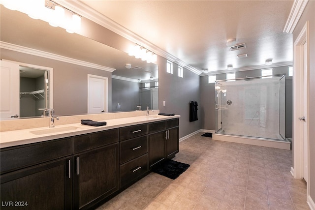 bathroom with crown molding, a shower with door, vanity, and a textured ceiling