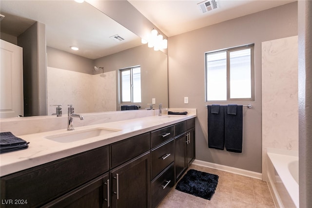 bathroom featuring vanity, tile patterned floors, shower / washtub combination, and a healthy amount of sunlight