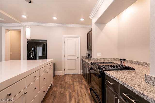 kitchen featuring black appliances, crown molding, decorative light fixtures, dark brown cabinets, and dark hardwood / wood-style flooring