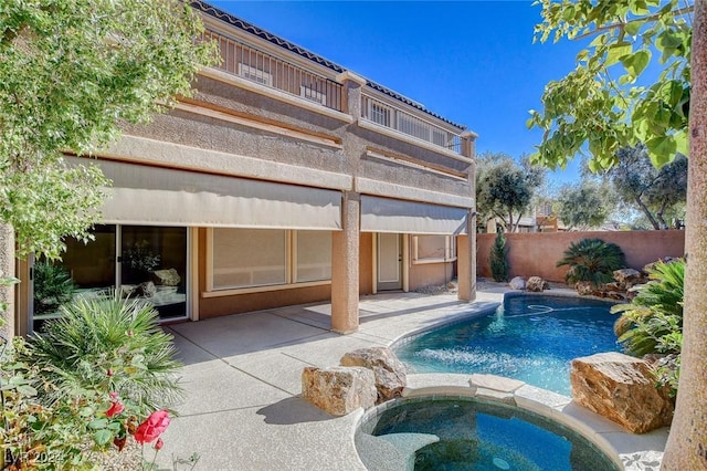 view of swimming pool featuring an in ground hot tub and a patio area