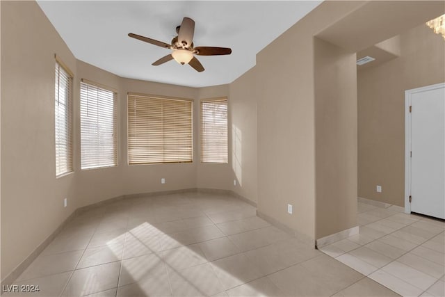 spare room featuring ceiling fan and light tile patterned floors