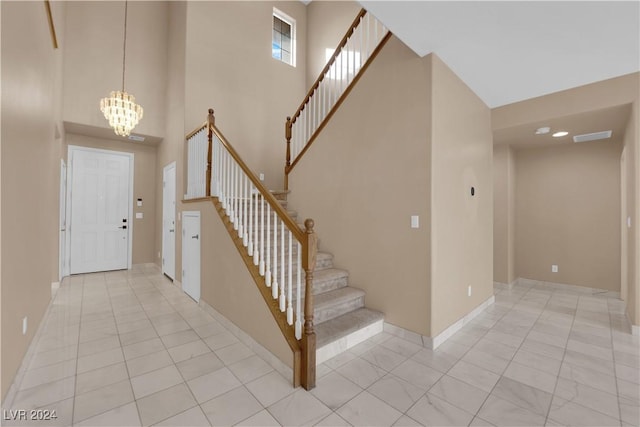 foyer entrance with a towering ceiling and an inviting chandelier