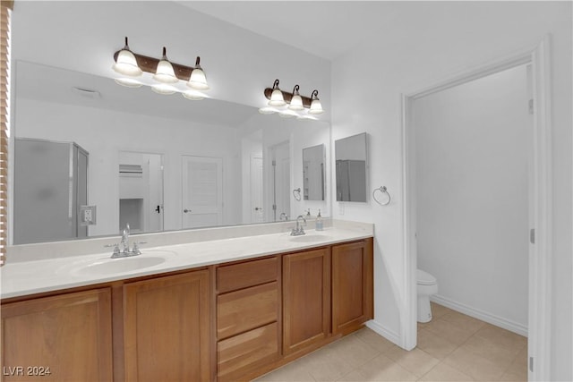 bathroom featuring tile patterned floors, vanity, and toilet