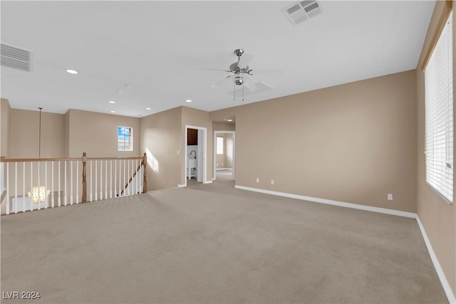 carpeted spare room with ceiling fan