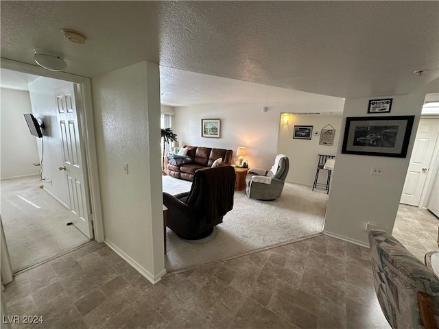 living room with carpet flooring and a textured ceiling