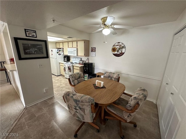 dining space featuring ceiling fan and a textured ceiling