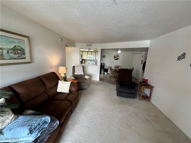 carpeted living room with a textured ceiling