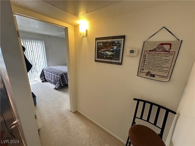 hallway with carpet floors