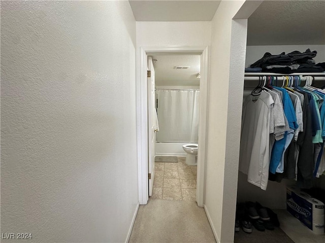 interior space with a textured ceiling and light colored carpet