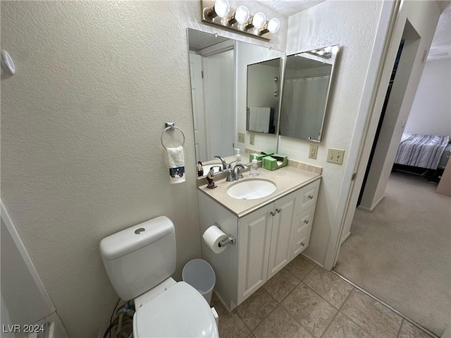 bathroom with tile patterned floors, vanity, and toilet