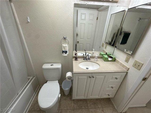 full bathroom with tile patterned floors, vanity, toilet, and bath / shower combo with glass door