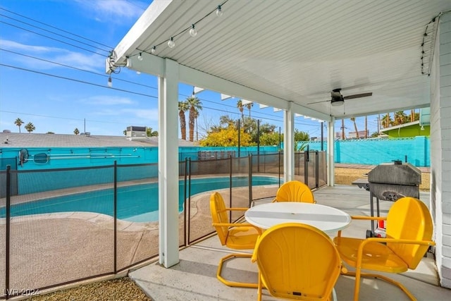 view of pool featuring ceiling fan and a patio