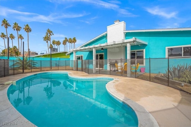 view of swimming pool with a patio area