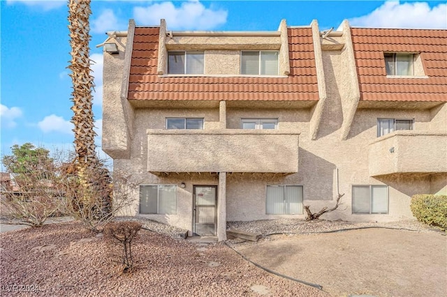 back of house with a balcony