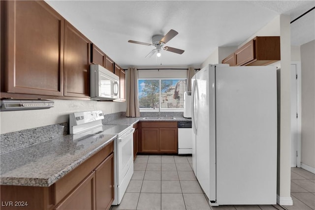 kitchen featuring ceiling fan, light tile patterned flooring, white appliances, and sink