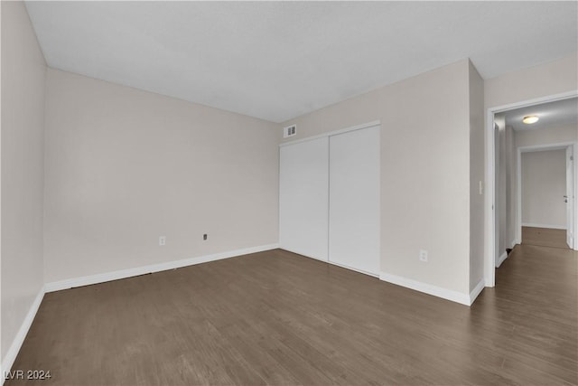 spare room with dark hardwood / wood-style flooring