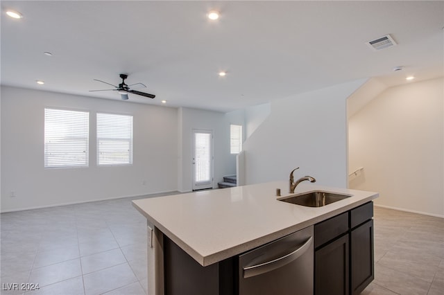 kitchen with dishwasher, sink, ceiling fan, light tile patterned floors, and an island with sink