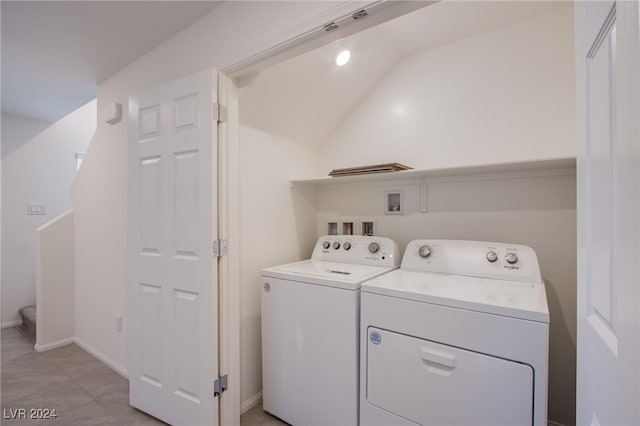 clothes washing area with washing machine and dryer and light tile patterned floors