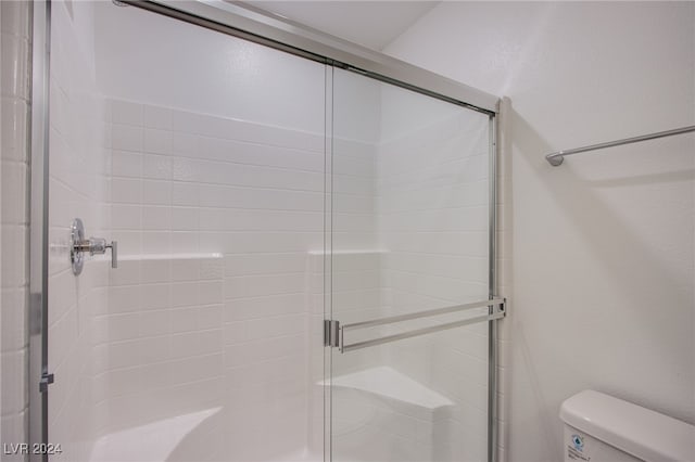 bathroom with toilet and walk in shower