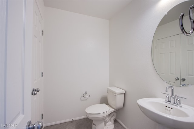 bathroom with tile patterned floors, sink, and toilet