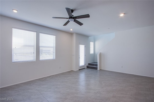 tiled empty room with ceiling fan