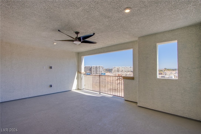 view of patio with ceiling fan and a balcony