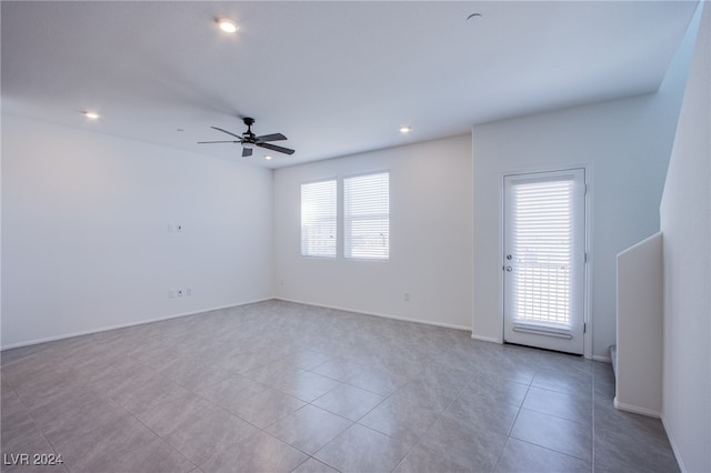 tiled empty room with ceiling fan