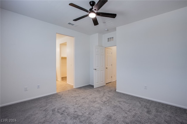 unfurnished bedroom with ceiling fan and light colored carpet