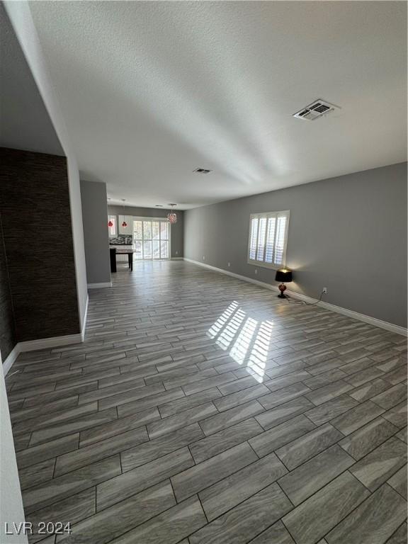 spare room with wood-type flooring and a textured ceiling