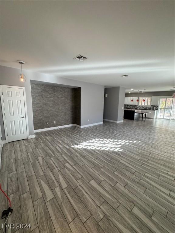 unfurnished living room with hardwood / wood-style flooring