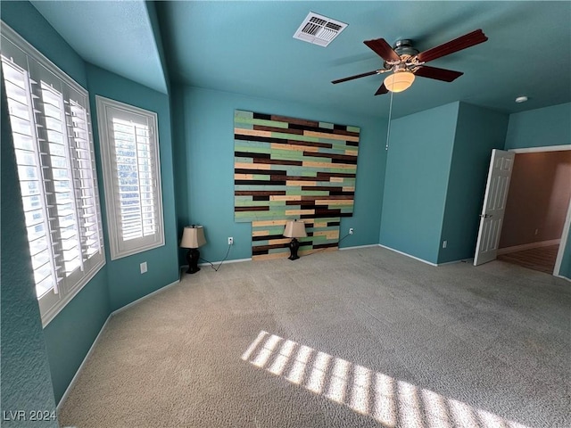 carpeted empty room with ceiling fan