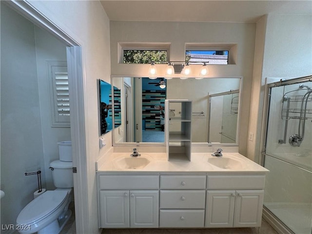 bathroom featuring an enclosed shower, vanity, and toilet