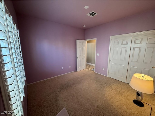 unfurnished bedroom with carpet floors and a closet