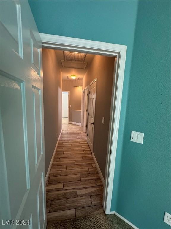 hallway with hardwood / wood-style floors