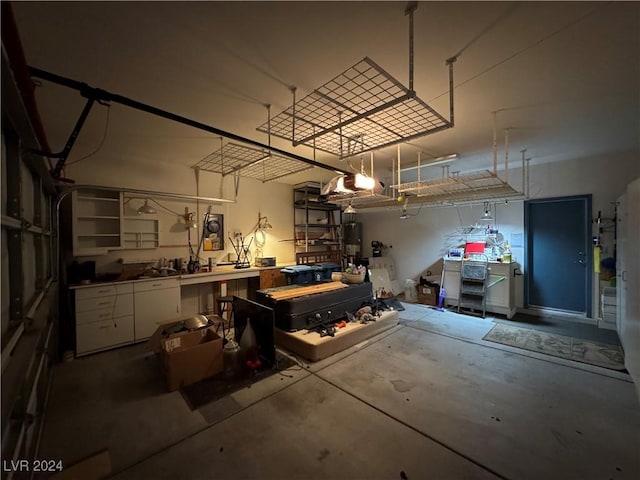 garage with a workshop area and a garage door opener