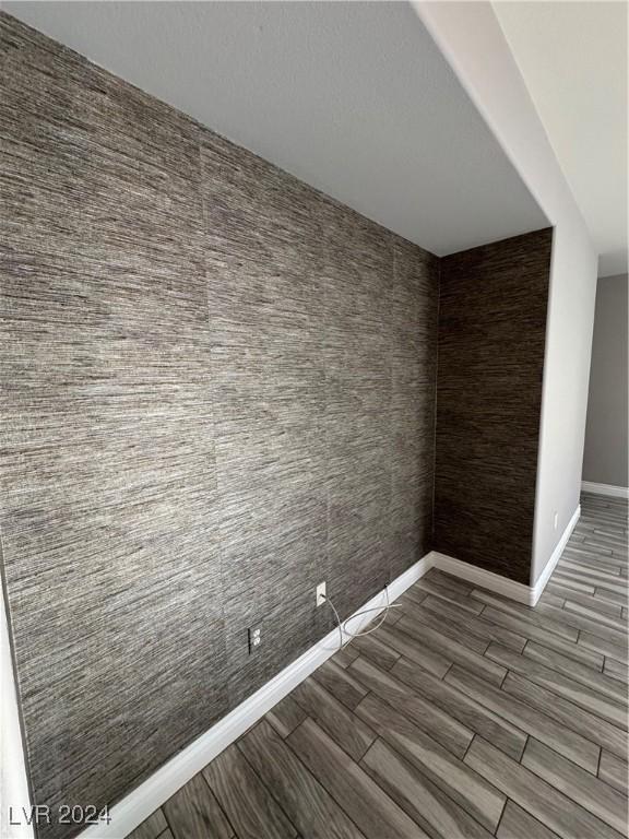 bonus room with dark hardwood / wood-style floors