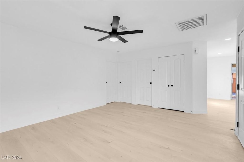 interior space with ceiling fan and light hardwood / wood-style floors