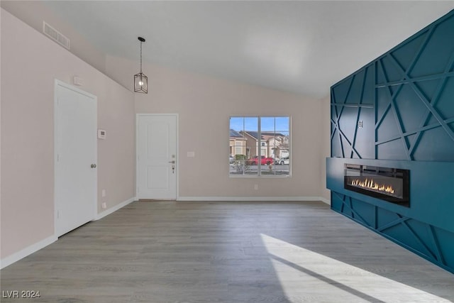 unfurnished living room featuring light hardwood / wood-style floors and lofted ceiling