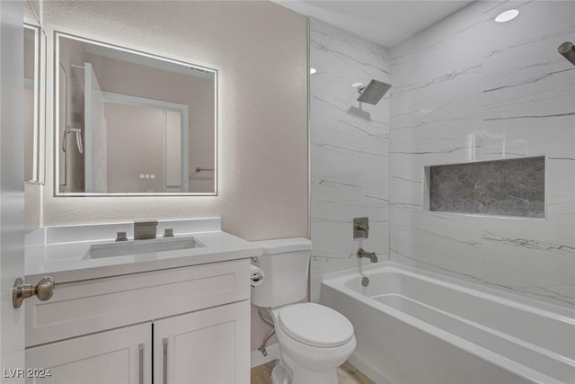 full bathroom featuring vanity, tiled shower / bath combo, and toilet