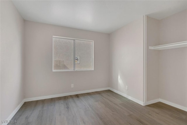 unfurnished room with light wood-type flooring