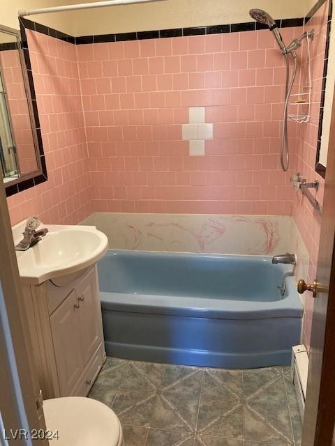 full bathroom featuring vanity, toilet, and tiled shower / bath