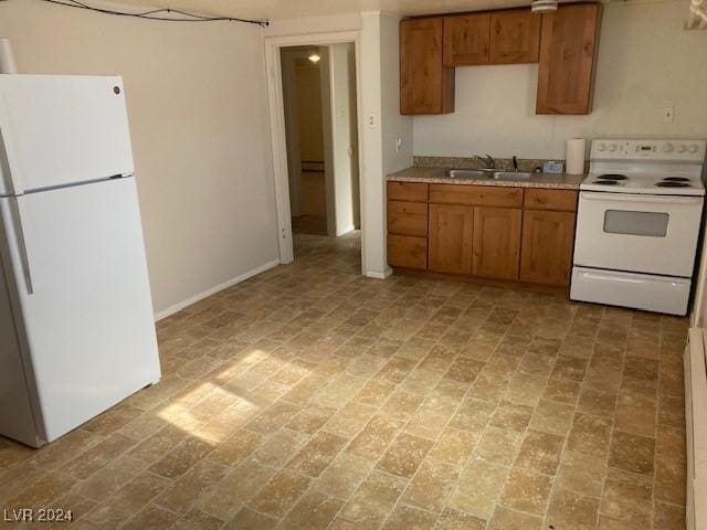 kitchen featuring white appliances and sink