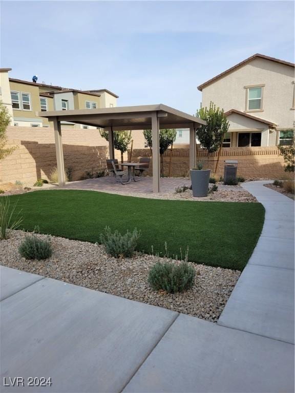view of yard with a patio, central AC unit, and fence