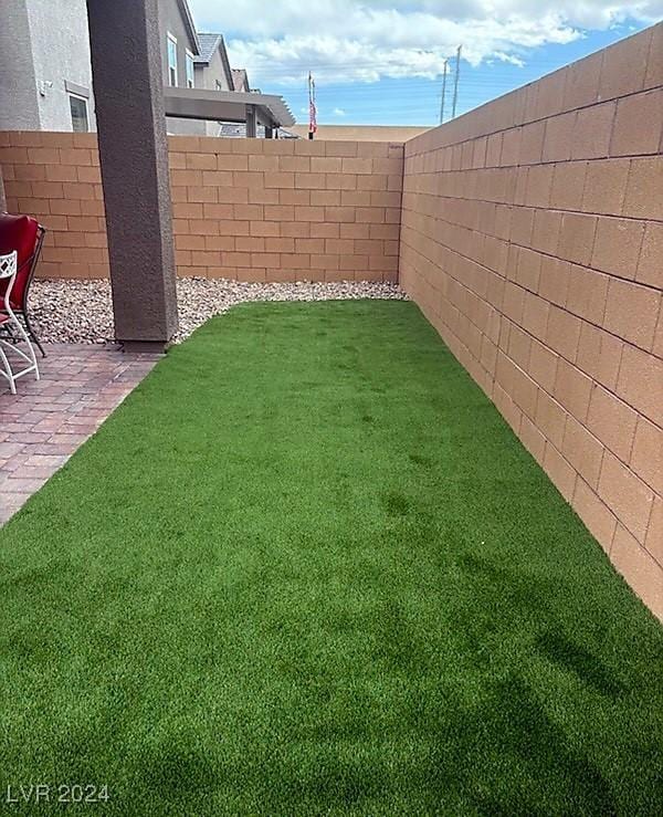 view of yard featuring a fenced backyard and a patio area