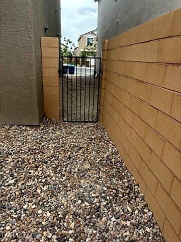 view of home's exterior featuring fence, a gate, and stucco siding