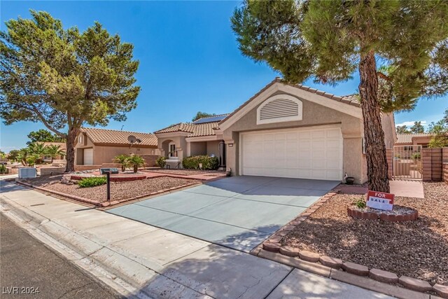 8705 Villa Ridge Dr, Las Vegas, NV 89134 - view of front facade featuring stucco siding, a garage, solar panels, and concrete driveway