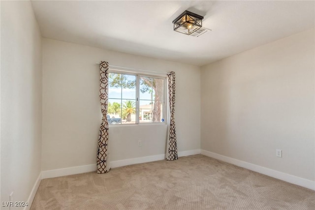 unfurnished room featuring light colored carpet