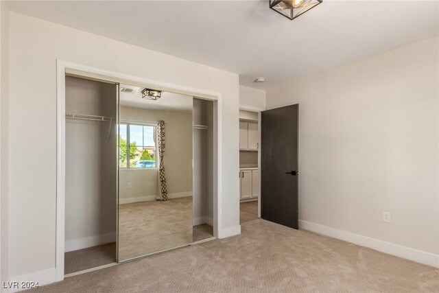 8705 Villa Ridge Dr, Las Vegas, NV 89134 - unfurnished bedroom with light colored carpet and a closet